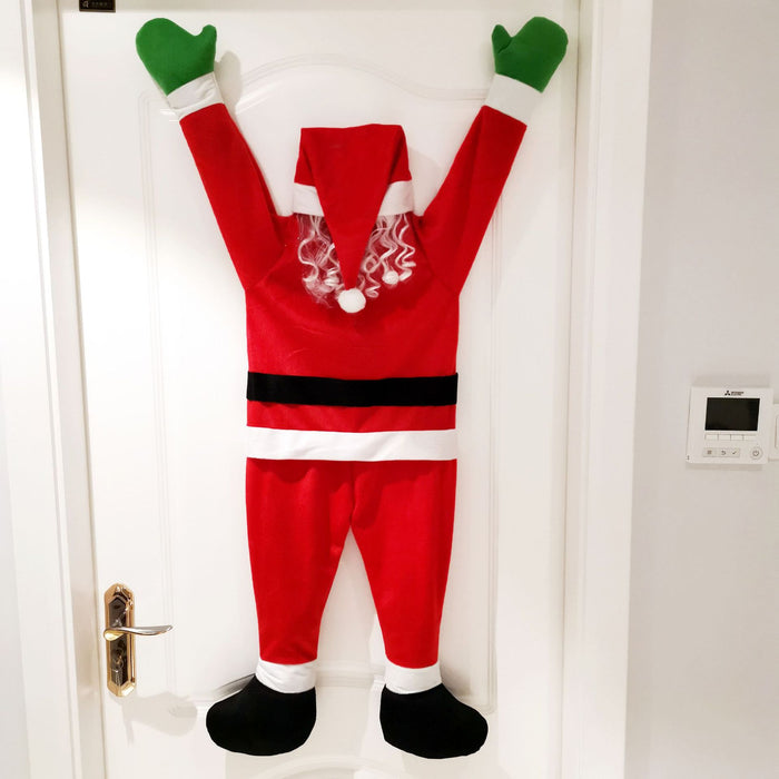 Babbo Natale si arrampica sul muro per decorare vestiti, ornamenti, regali, decorazioni natalizie
